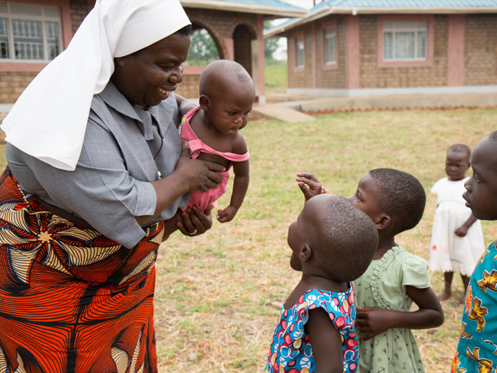 A Nun attending to children