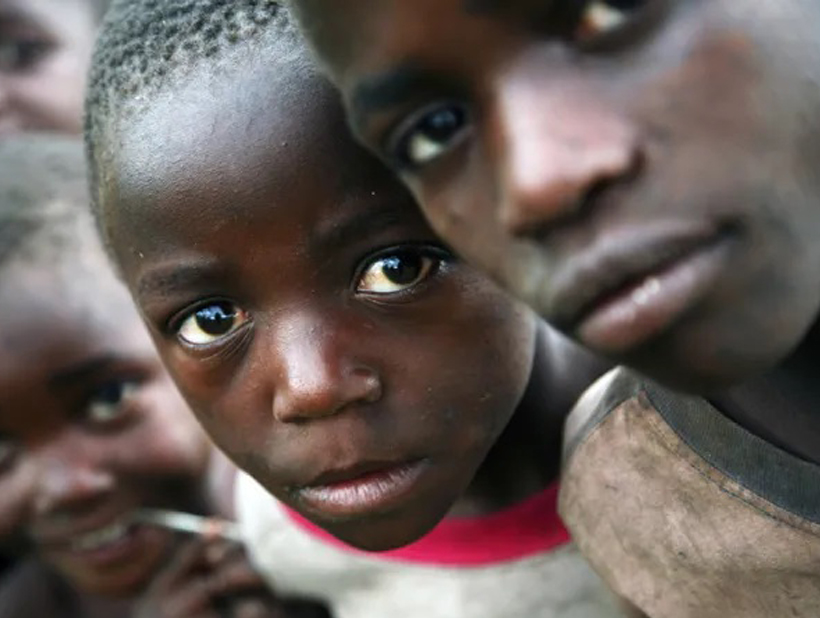 A little boy laughing while reading the Holy Bible
