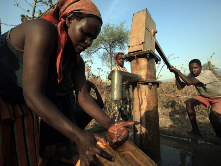 Congolese Woman Collecting Water from a Borehole